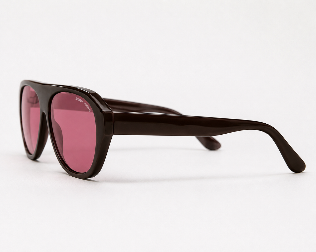 Noir espresso brown shield sunglasses with pink tinted lenses, angled side view — Shady Views